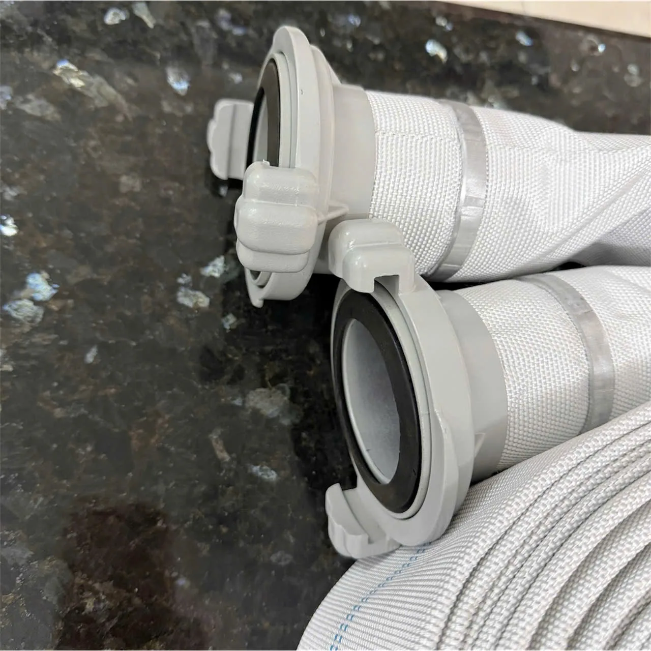 Vòi chữa cháy 83Mec D65-16bar-20m kèm khớp nối (2) Cận cảnh hai khớp nối ở đầu vòi chữa cháy màu trắng